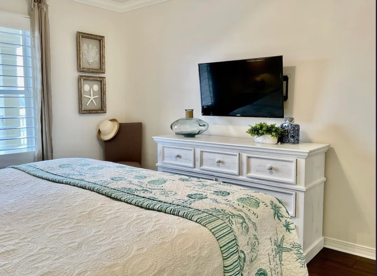 Beautiful bedroom with wall mounted TV for relaxing