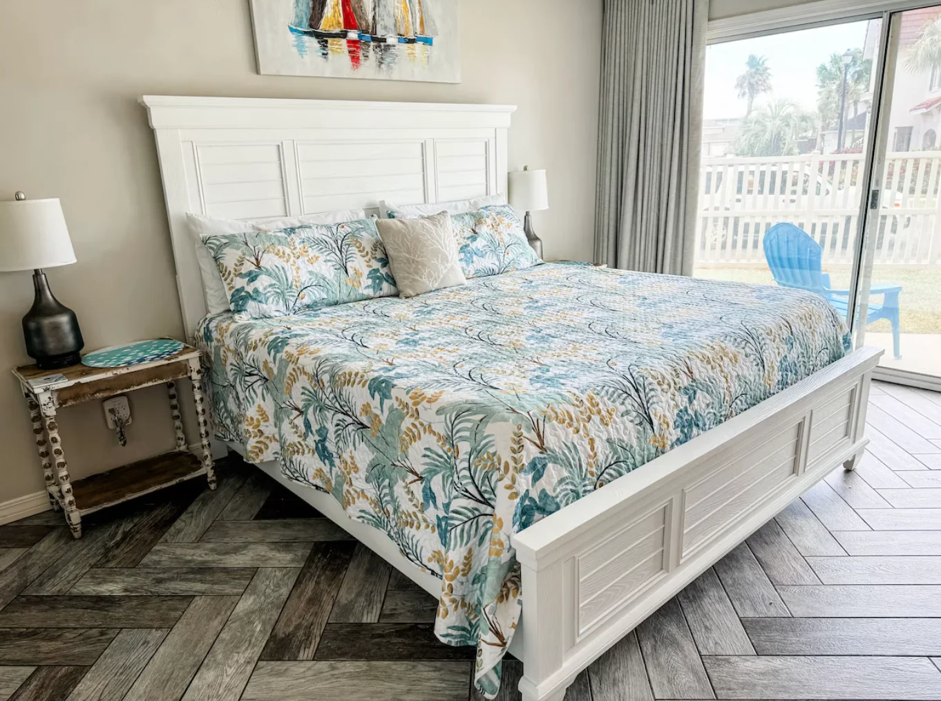 Primary bedroom with king-sized bed. Also has sliding door to patio.