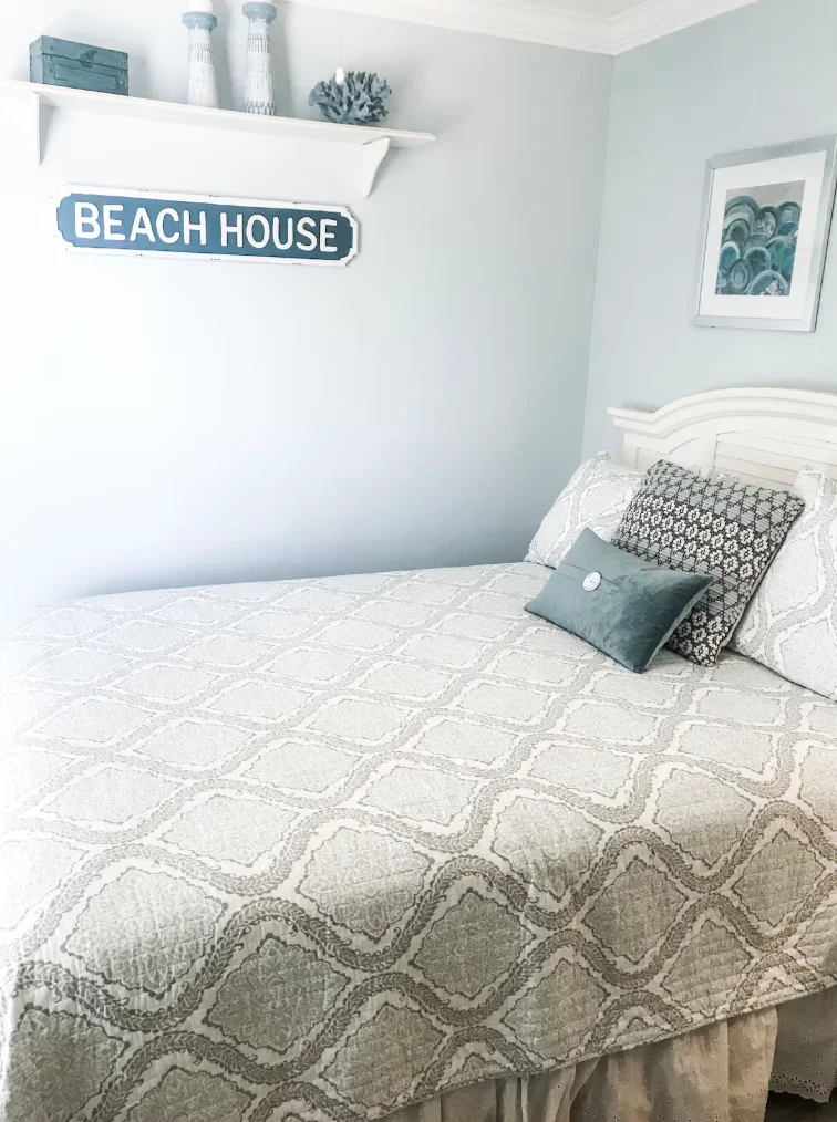 The guest bedroom features a queen size bed