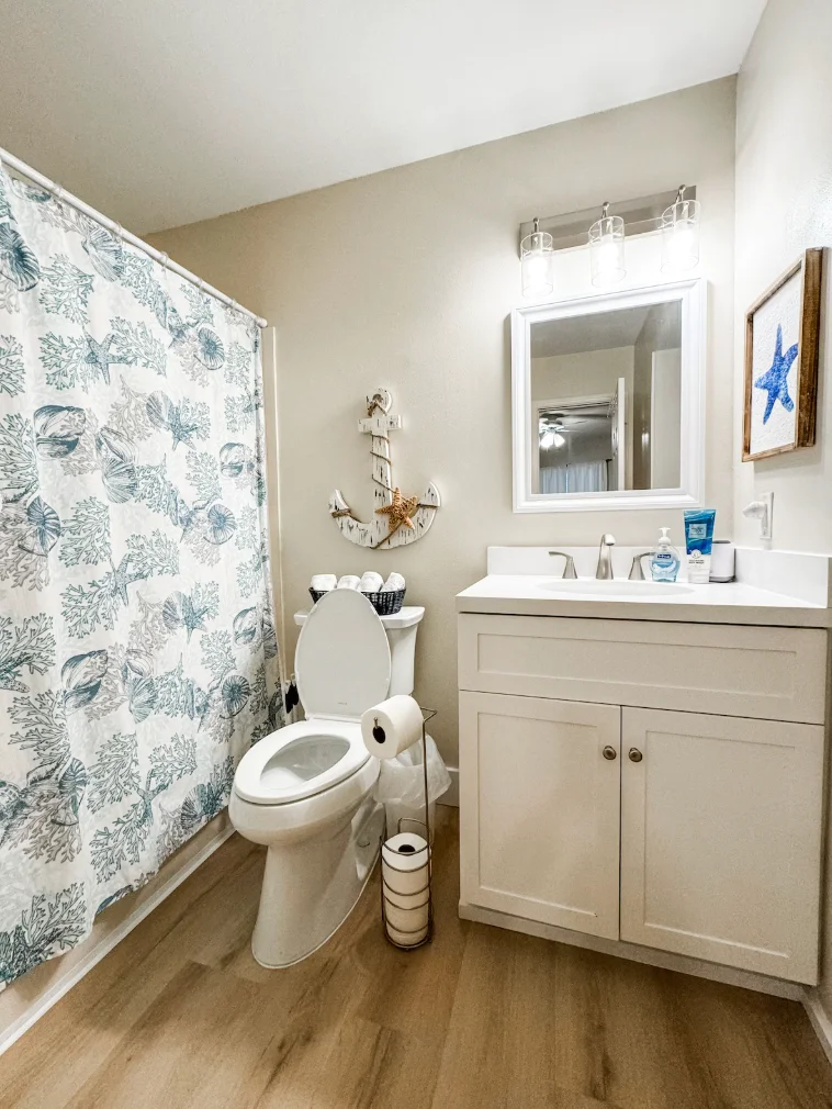 The guest bathroom is connected to the guest bedroom and the hallway