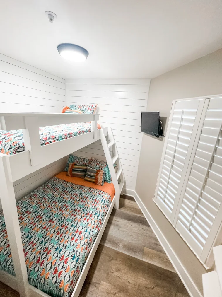 Newly updated bunk room with barn door. (Twin/Full beds). There is extra storage space built into the wall and a TV.