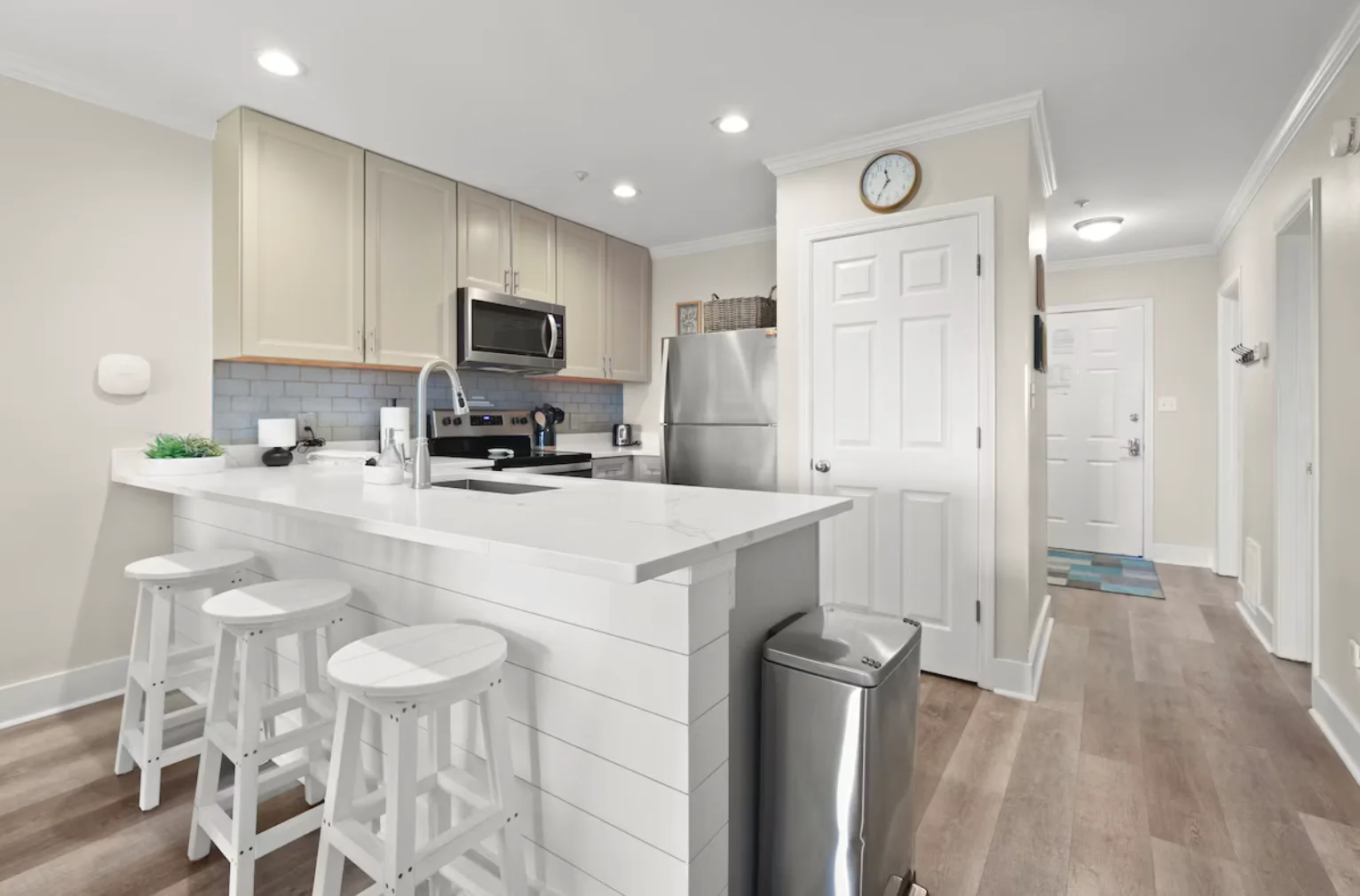 There is additional seating for guests on the kitchen bar.