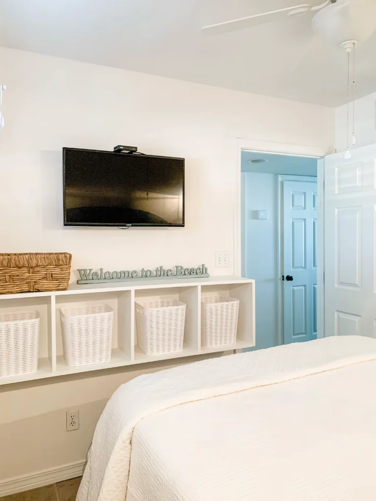 Guest bedroom features a queen size bed and a TV.