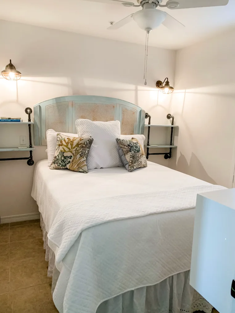 Guest bedroom features a queen size bed and a TV.