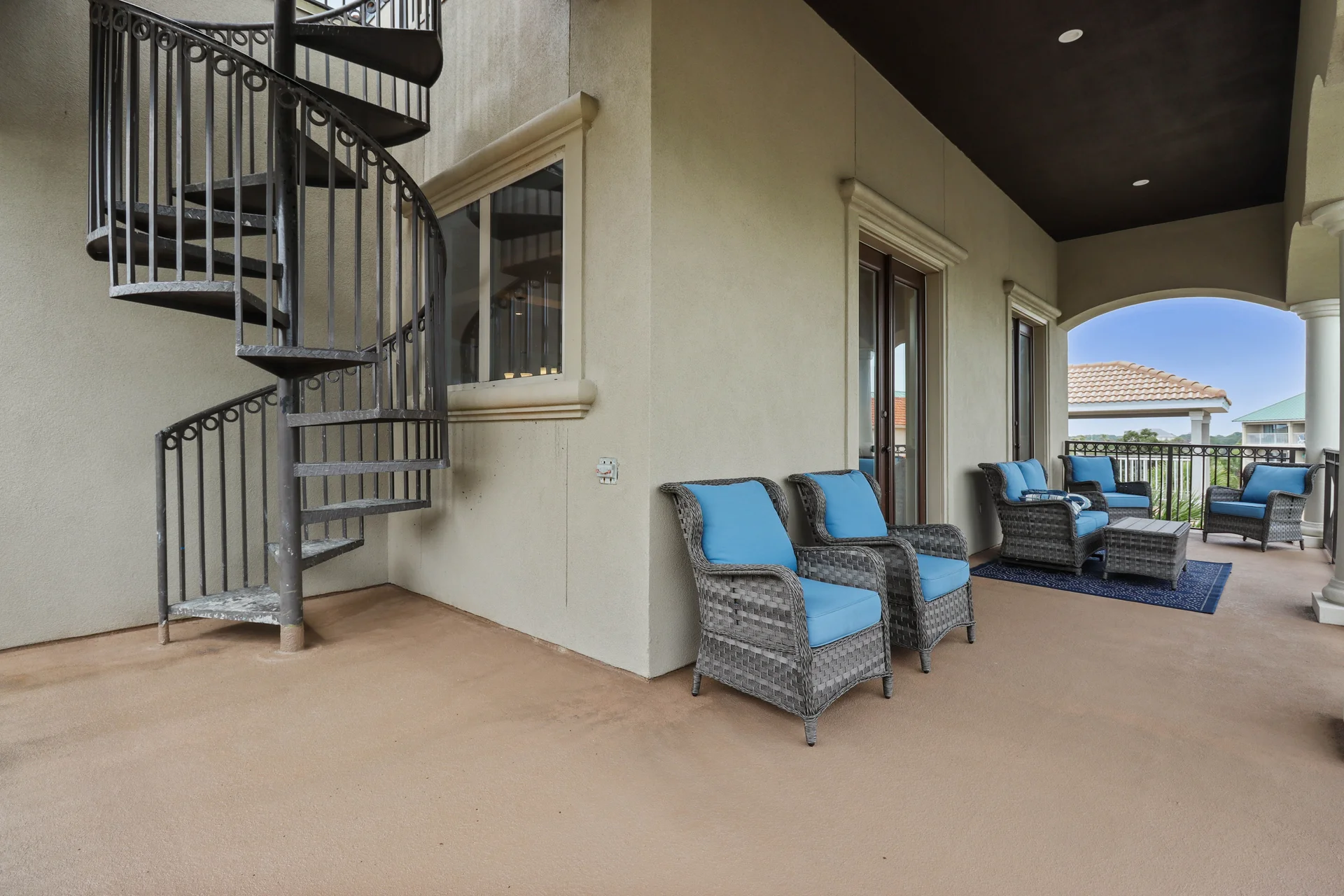 Spacious third floor balcony with spiral staircase to the rooftop gulf views