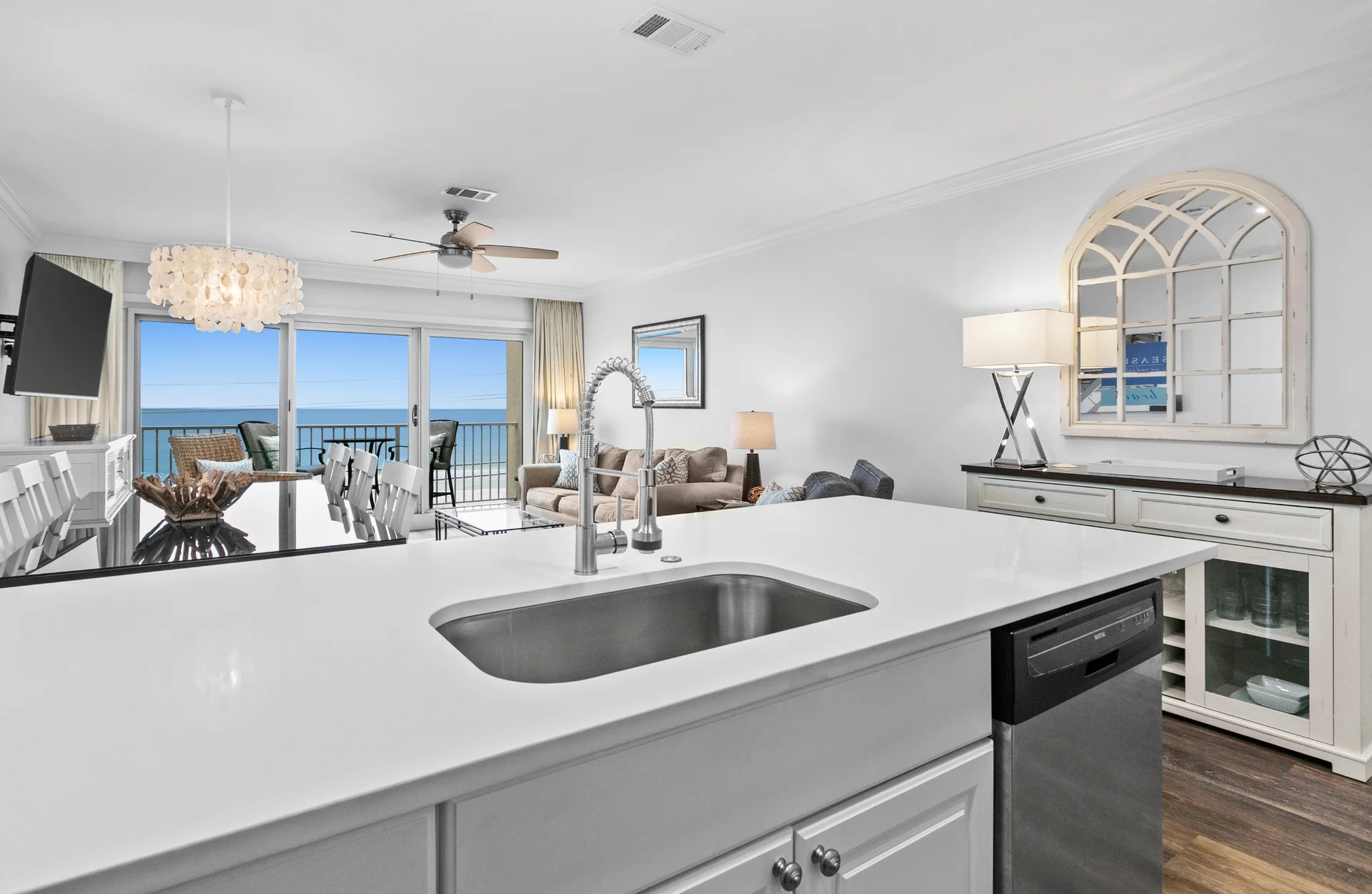 Beautiful white granite countertops in the fully renovated kitchen overlook the open living/dining area, balcony and the colorful waters of the Gulf Coast. A service buffet with wine rack neatly holds extra barware, dishes and games for easy access.