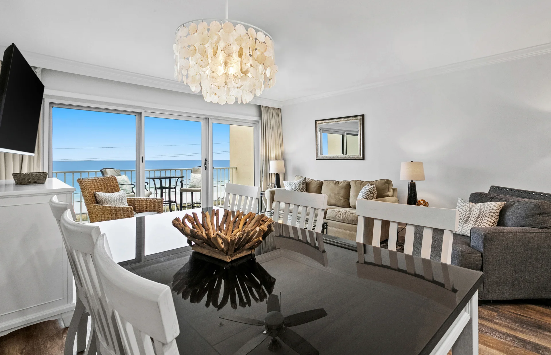 Relax and unwind in a bright, comfortable open living space featuring a 65” smart TV for streaming your favorite shows and movies. The room includes a new white beachy-style sleeper sofa with an upgraded 4" gel mattress for added comfort. A large dresser provides plenty of storage space, while the spacious dining table comfortably seats six, making it ideal for meals, game nights or gathering with family and friends.