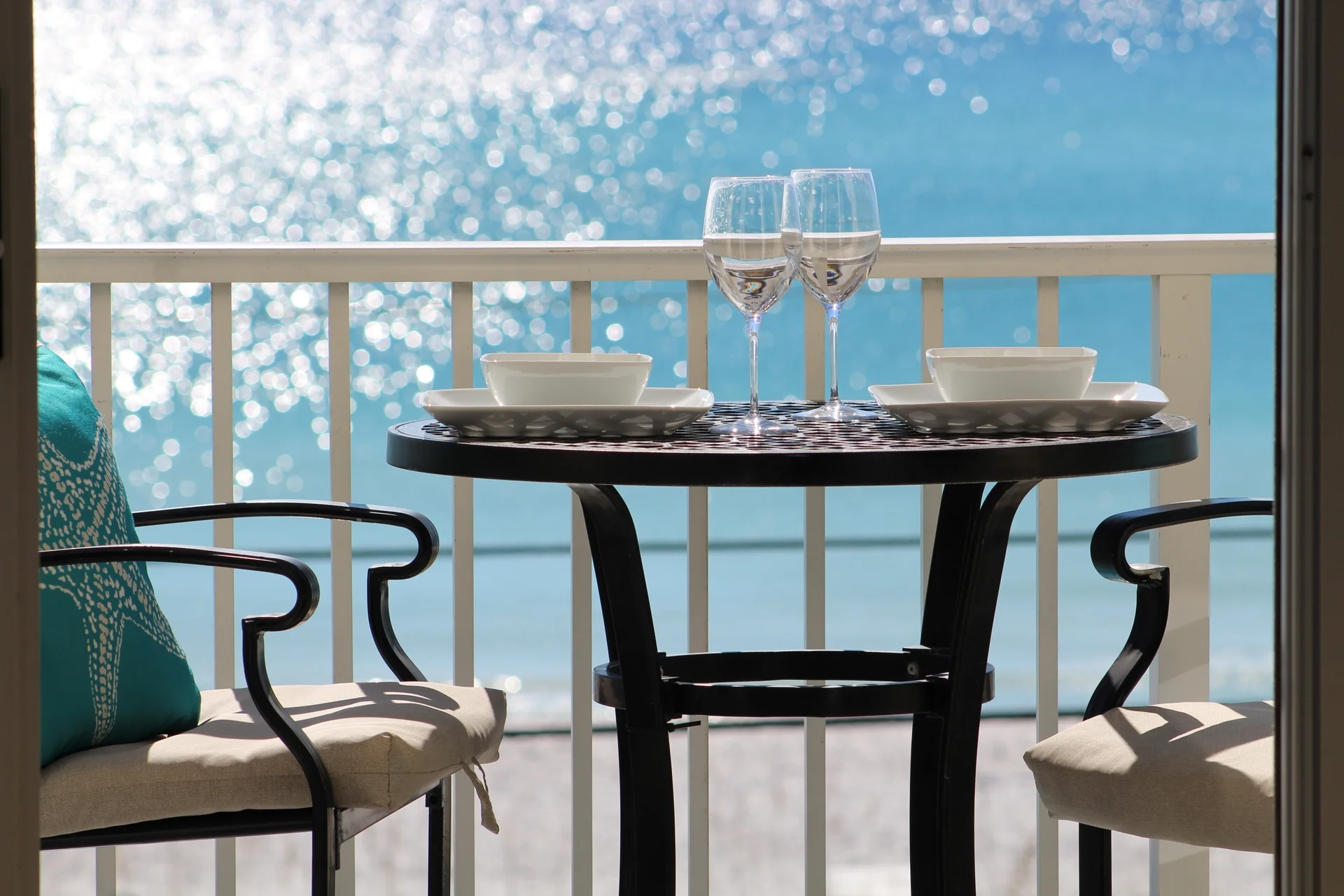 Enjoy unforgettable sunrise and sunset views accompanied by refreshing coastal breezes from your private balcony, thoughtfully furnished for ultimate relaxation. There's two chaise lounge chairs with a convenient side table—perfect for sipping morning coffee or unwinding with evening cocktails. For dining with a view, the balcony also features a bar-height table with two armchairs, creating the perfect setting for alfresco meals overlooking the beautiful Gulf Coast.